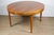 Beautiful Scandinavian teak dining table from the 1960s, featuring an elegant circular top with a built-in central...
