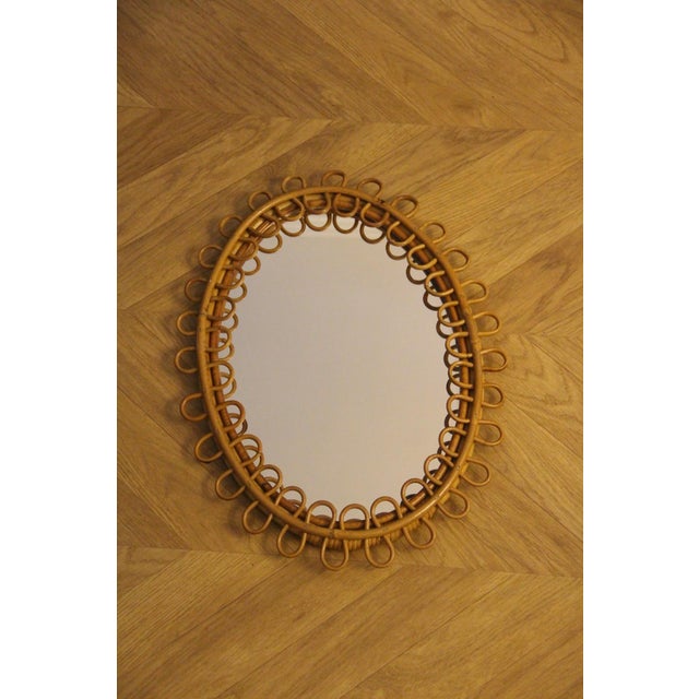 This highly decorative mirror was made in Italy in the 1960s. It features a design typical of that era and is entirely...