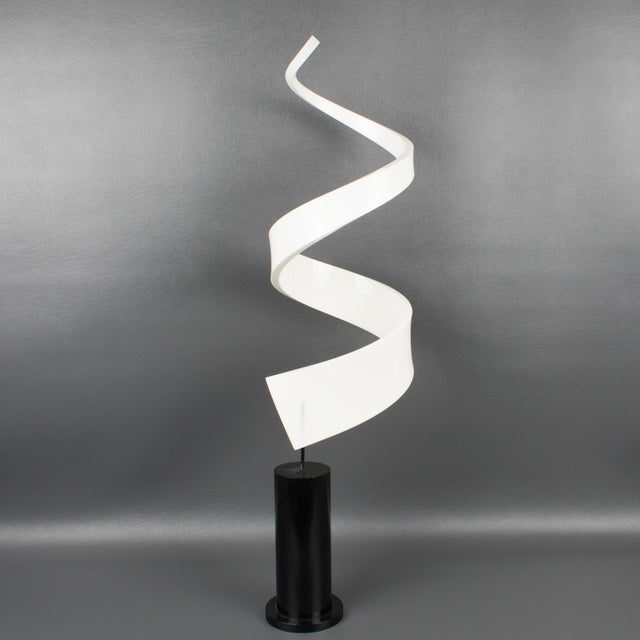 This stunning Lucite or Plexiglass sculpture features an abstract, geometric swirl shape with a milky white color, mounted...