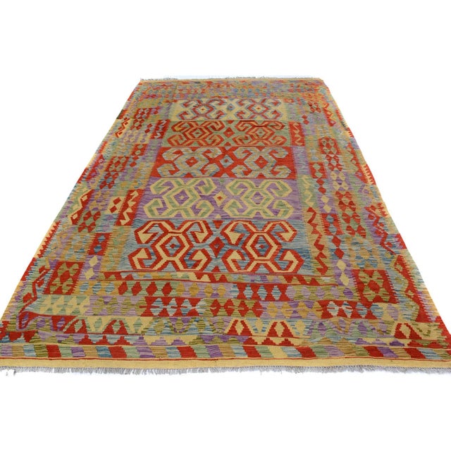 "Add a touch of elegance to your home with this casual chic hand woven Tribal Kilim wool rug. Constructed on a loom by...