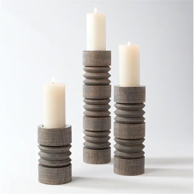 Contemporary large-scale carved candlesticks with nickel candle cup inserts; weathered grey finish by Studio A partnered...