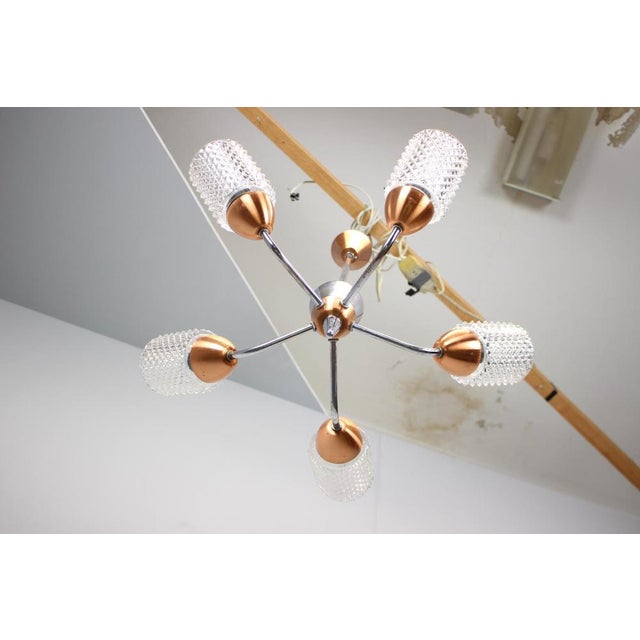 A distinctive Mid-Century chandelier designed and manufactured by Drukov Brno in the 1970s, Czechoslovakia. The piece...
