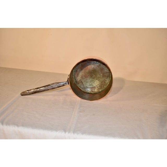 19th century copper saucepan from France. The copper pot is dovetailed with brass and the edge of the pot is rolled. The...