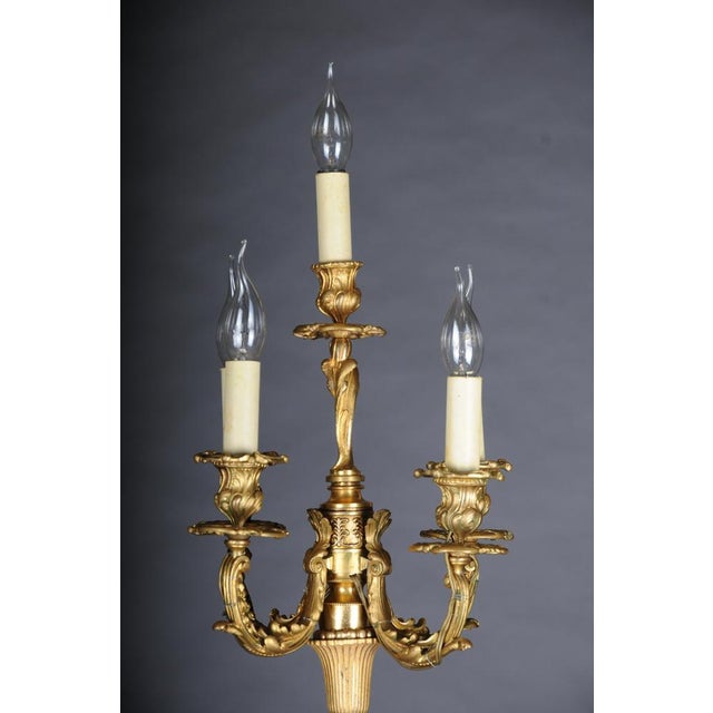 Louis XV parlor lamp, five-light; bronze, gilt and partially dark-patinated. Finely chased, naturalistically designed base...
