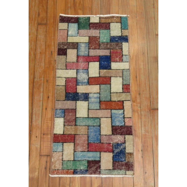 A mid-20th century bright colored Turkish rug with a deco inspired Tetris game mosaic style design. A fun rug to own
