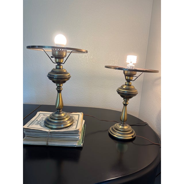 Distinctive pair of circa-1960s accent lamps featuring sculptural hurricane-inspired silhouettes and broad brass-tone...