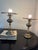 Distinctive pair of circa-1960s accent lamps featuring sculptural hurricane-inspired silhouettes and broad brass-tone...