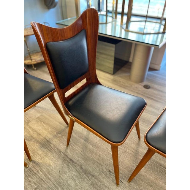 Vintage Italian design chairs from the 1950s, attributed to Carlo Ratti. Made with a wooden frame, featuring an...