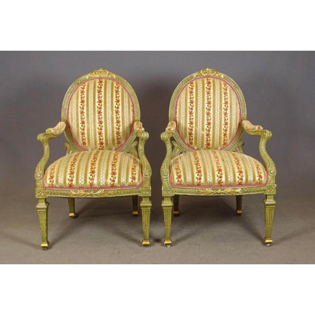A very fine pairnof Louis XVI arm chairs painted in palest green and gold and covered in quality velvet