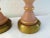 Pretty pair of light pink frosted glass lamps with brass bases. Frosted pink glass features a delicate hand-painted...