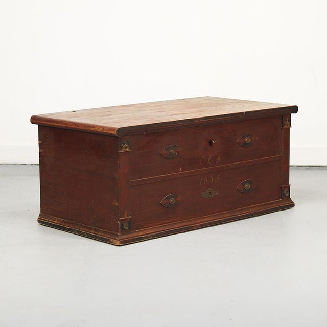 Painted Swedish folk art chest, dating from 1845. The chest is painted in a warm oxblood red color and decorated with...