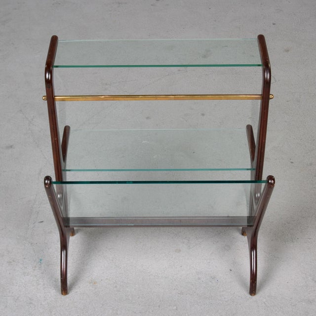 A sculptural mid-century Italian magazine rack and side table in richly toned mahogany. The elegantly curved uprights...