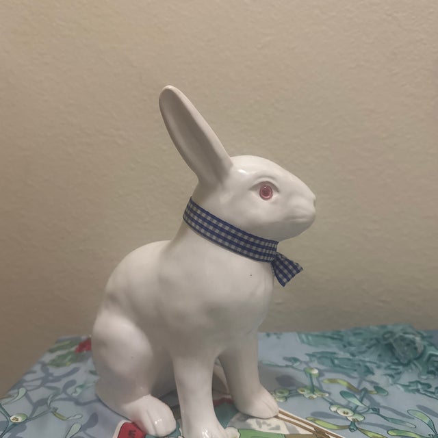 This charming vintage bunny features a clean white glaze, distinct pink eyes, and a classic blue and white gingham fabric...
