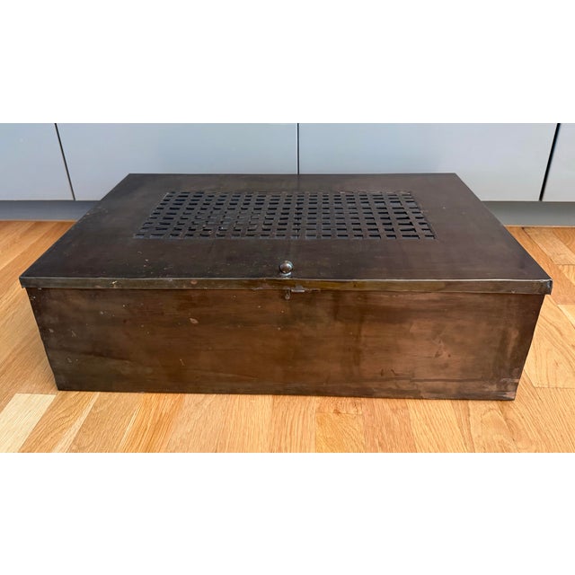 Large vintage tinplate metal box featuring a glass insert in the lid and woven metal detail and glass dividers inside....