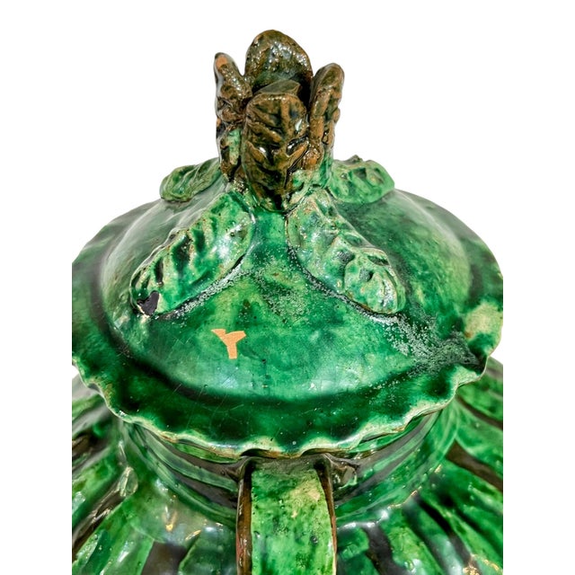 Beautiful bright green glazed terracotta pot with black accents. Lid with applied leaf decoration. Sourced in France.