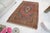 This is a vintage Turkish Oushak rug from the Mid 20th Century. The piece was hand-knotted.