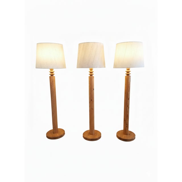 This elegant set of three floor lamps was designed by Uno Kristiansson for Luxus in Sweden during the 1970s. Crafted from...