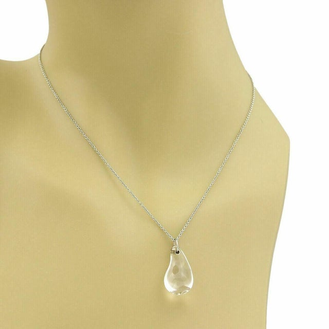 The Tiffany & Co. Peretti Platinum Rock Crystal Tear Drop Pendant Necklace is a stunning piece of fine jewelry. Signed by...
