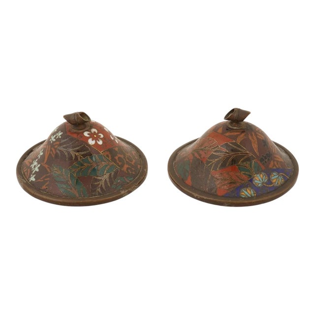 A pair of antique Japanese cloisonne enamel covered jars dating to the Meiji period, each featuring a dark brocade ground...