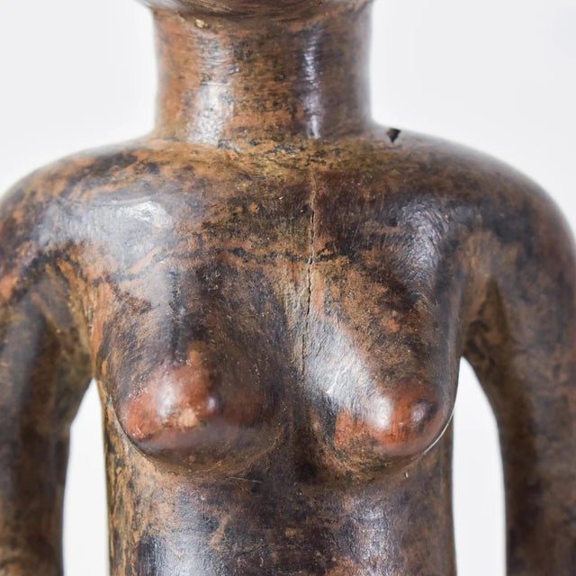 A superb Nyamwezi Mwana Hiti wood-carved figure standing at 18 inches in height, adorned with glass beads.Â The Mwana Hiti...