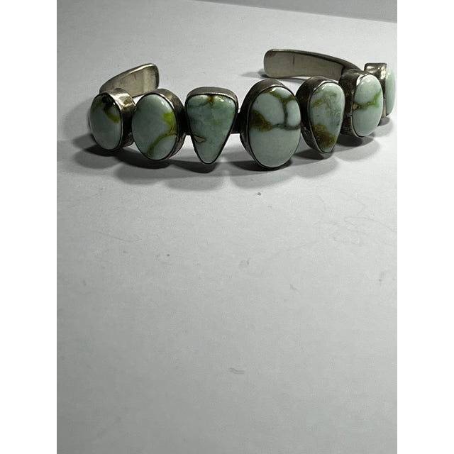 Six high-quality Turquoise cabs adorn This sturdy Sam Lewis cuff Measures 6 5/8 inch extremely firm
