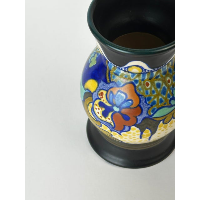 This Dutch Gouda vase by Zuid, produced in Holland in 1922, features the Corona pattern with richly hand-painted floral...