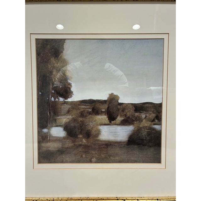 An elegant framed landscape print by Trowbridge, featuring a serene countryside scene rendered in a beautifully subdued,...