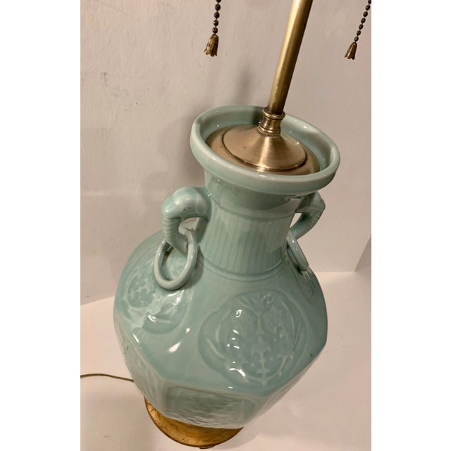 Early 20th Century working Chinese celadon green porcelain lamp with double sockets and double handled. The handles are...