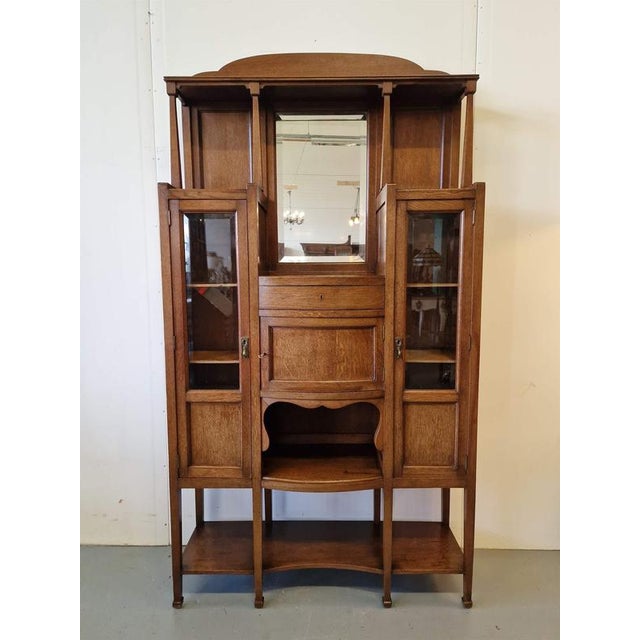 Elegant art deco display case.Oak, beveled glass.Belgium.1930s.Dimensions: height 191cm; width 100cm; depth 34cm