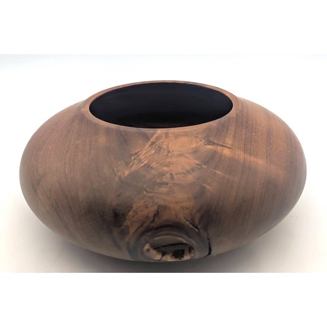 Offered is a handcrafted and artisan-signed Walnut wood bowl that features a distinctive natural hole or void on the...