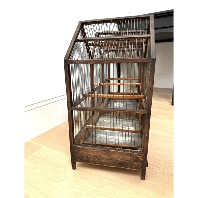 This is a large antique mid 19th century architectural model primitive birdcage. Perfect as sculptural piece in a Rose...