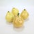 A group of four figural pottery pear shaped salt and pepper shakers. In the form of yellow pears with twig stems. Perfect...