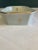 This elegant porcelain set includes a tapered cup and a small octagonal soap dish, both adorned with delicate gold fleur-...
