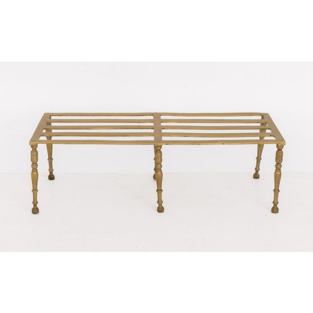 Georgian Brass Footman, 19th century or earlier, the slatted top above six legs. 9.25" H x 29.5" W x 11.75" D. Provenance:...