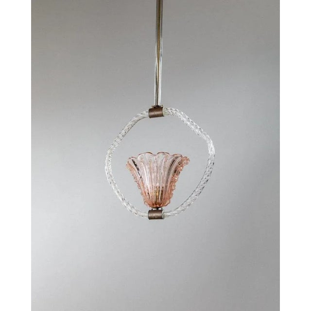 This rare and really long vintage murano glass chandelier was designed by barovier e toso in the 1940s and embodies the...