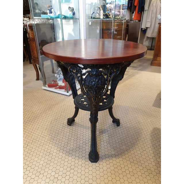 Teak top and cast iron structure