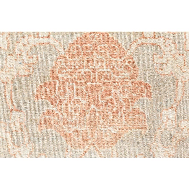 This antique Persian Tabriz rug, dating back to around 1920, showcases an intricate all-over floral pattern with delicate...