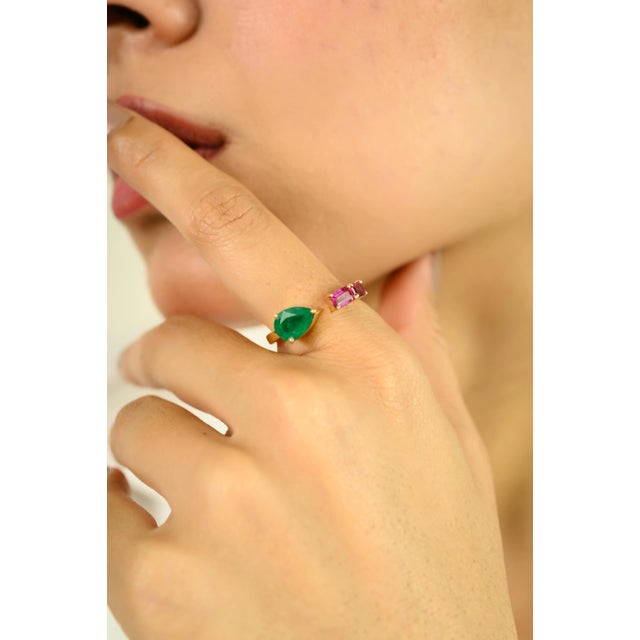 Modern elegance meets vibrant color in this stunning 14K yellow gold open ring, featuring a unique combination of a vivid...