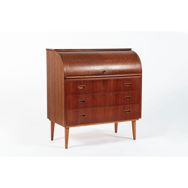 This vintage mid century Scandinavian modern teak wood rolltop secretary desk cabinet by Egon Ostergaard was made in...