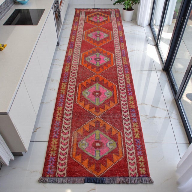 This hand-knotted runner from Southeast Anatolia represents a vibrant era of mid-century village folk art. Woven in the...