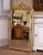 This elegant antique wall mirror captures the refined symmetry and decorative restraint of the Louis XVI style. Crafted in...