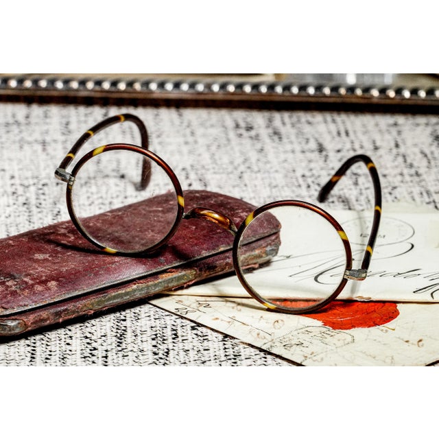Step back to the whimsical elegance of the 1920s with this rare and endearing pair of eyeglasses, an enchanting relic from...