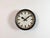 This wall clock was produced by Siemens in Germany during the 1950s. It features a black metal frame, a metal dial and a...