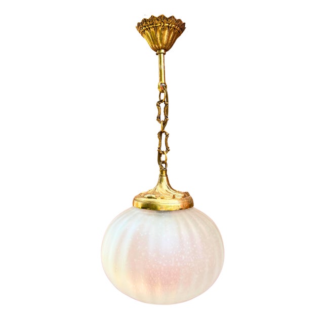 Softly glowing like a moon suspended in midair, this elegant french pendant light combines a frosted glass globe with...