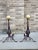 Pair of American brushed brass ball finials and hammered wrought iron andirons with scrolled legs and stylized penny feet....