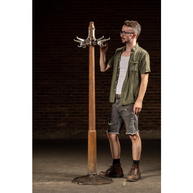 c. 1920s-1930s; (likely) Koken Barbers' Supply Co. - St. Louis, MO A tall oak stand fitted with a heavy iron base and a...