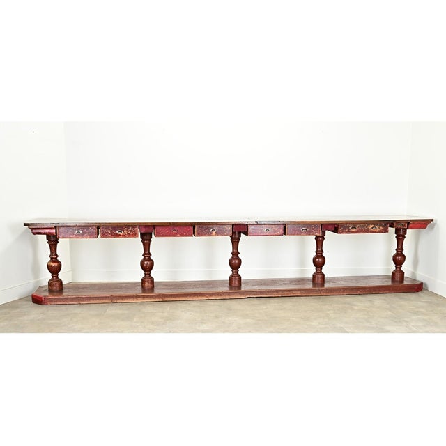Dimensions: 33 ¼” H x 173 ¼” W x 27 ¼” D This massive Spanish 19th century shop counter is over 14 feet long (14’-5...