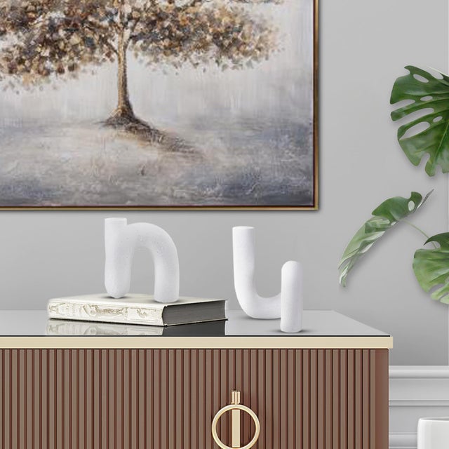 Discover a contemporary take on minimalist design with this abstract tubular vase. The beauty of its fluid curves and...