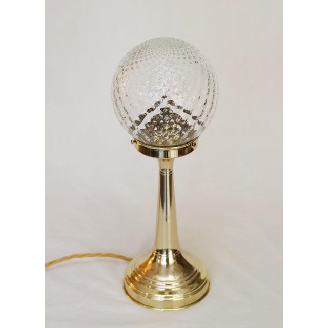 Art Nouveau floor lamps Art Nouveau table lamps, circa 1915. Trumpet-shaped columns. Original glass shades. The lamps have...