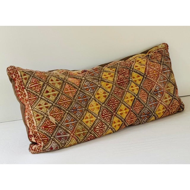 A vintage Sumak kilim custom made as a pillow. The interior with newer synthetic cushion.